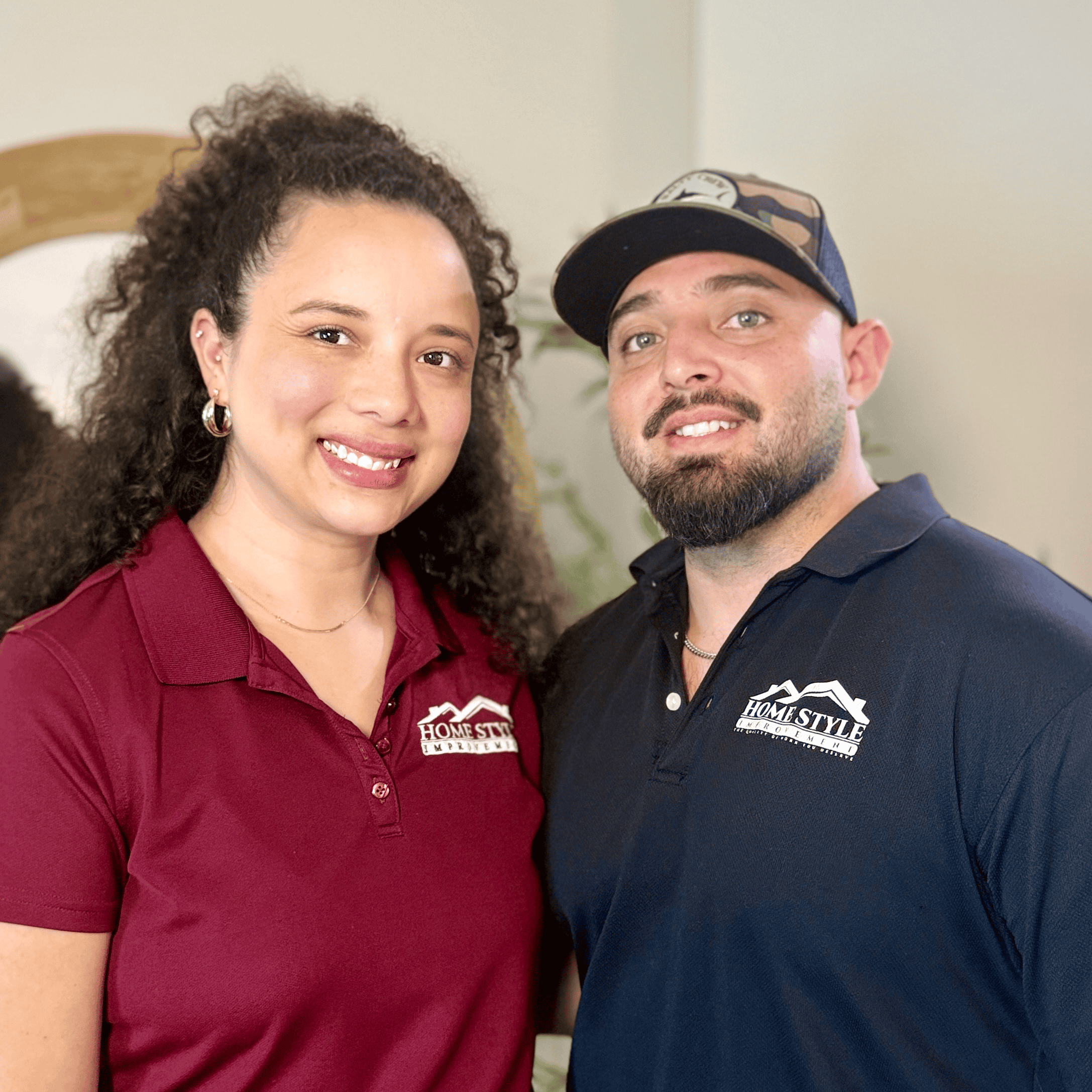 Friendly home improvement professionals posing indoors for a photo.