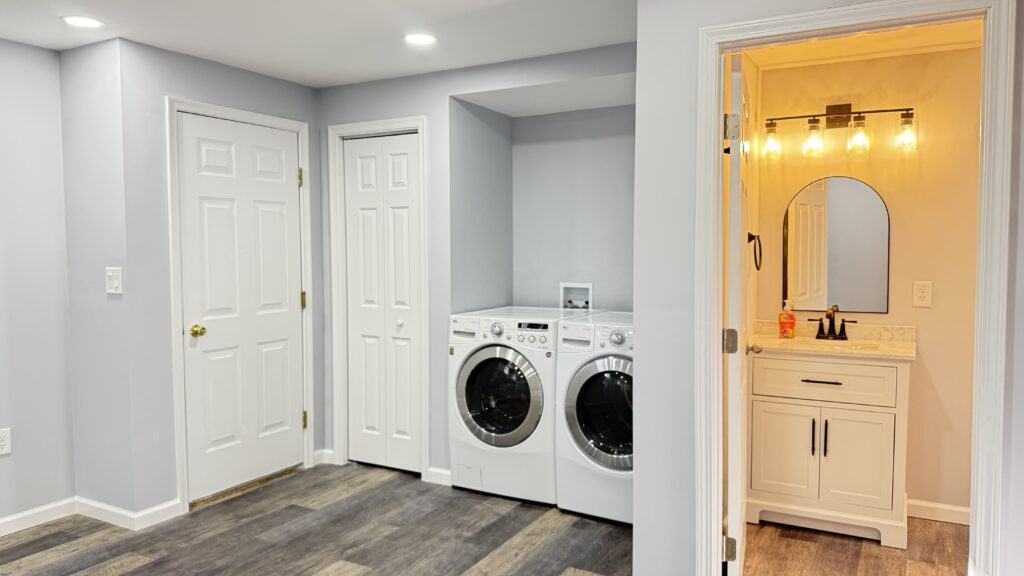Laundry room with front-loading washer and dryer in a clean, modern space.