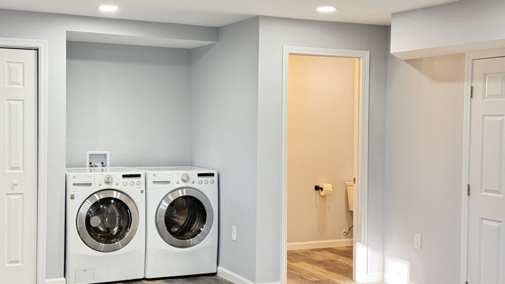 Modern laundry room with washer and dryer in a bright, clean space.