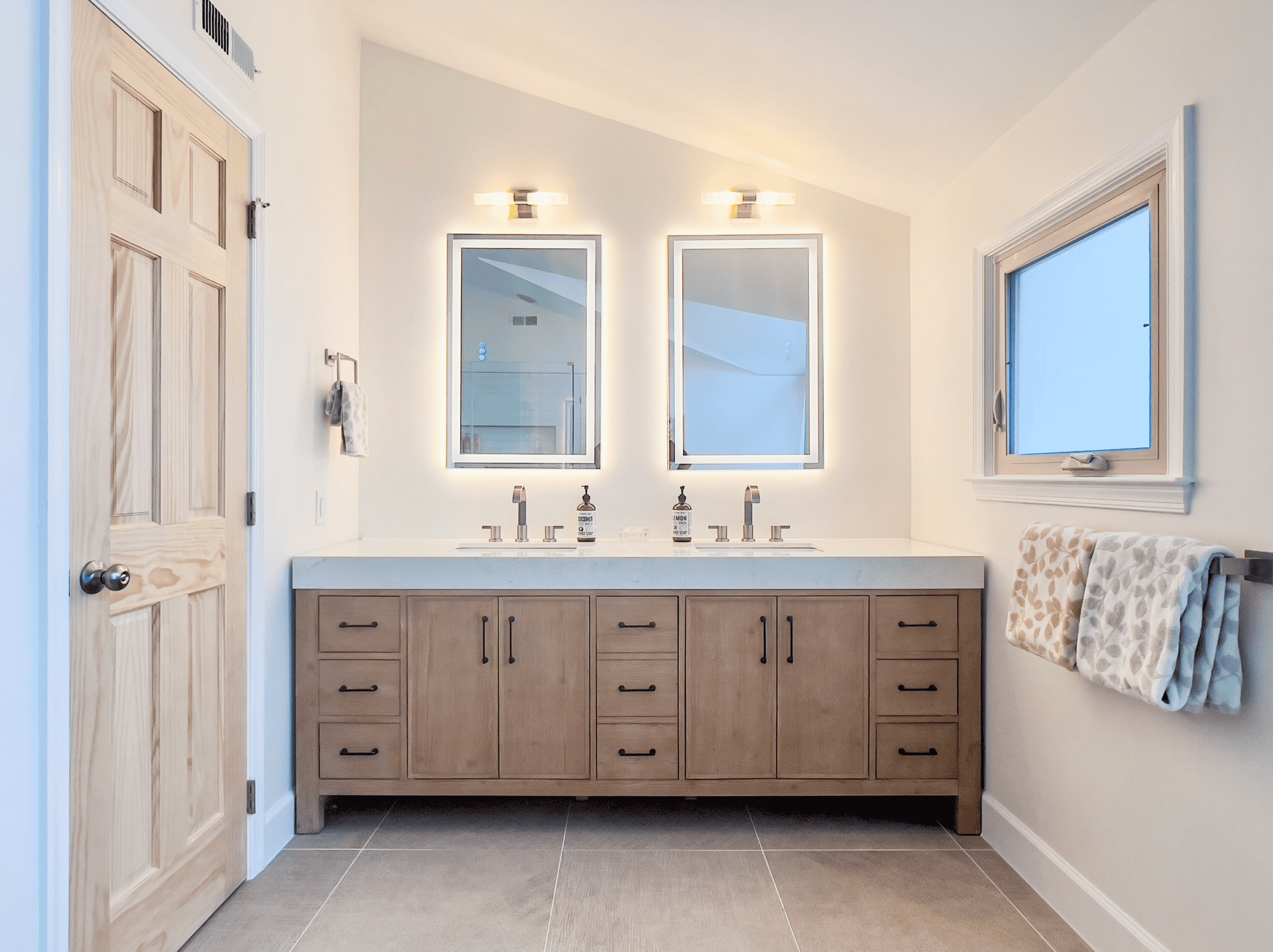 Bathroom vanity with dual sinks and mirrors.