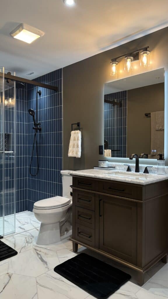Bathroom with walk-in shower and stylish vanity.