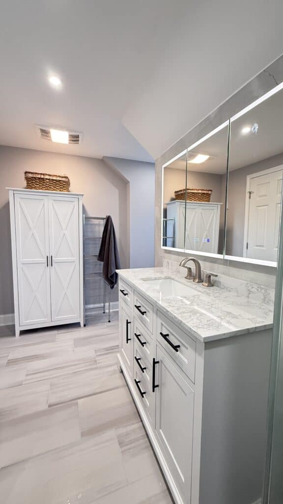 Bathroom vanity with marble countertop and large mirror.