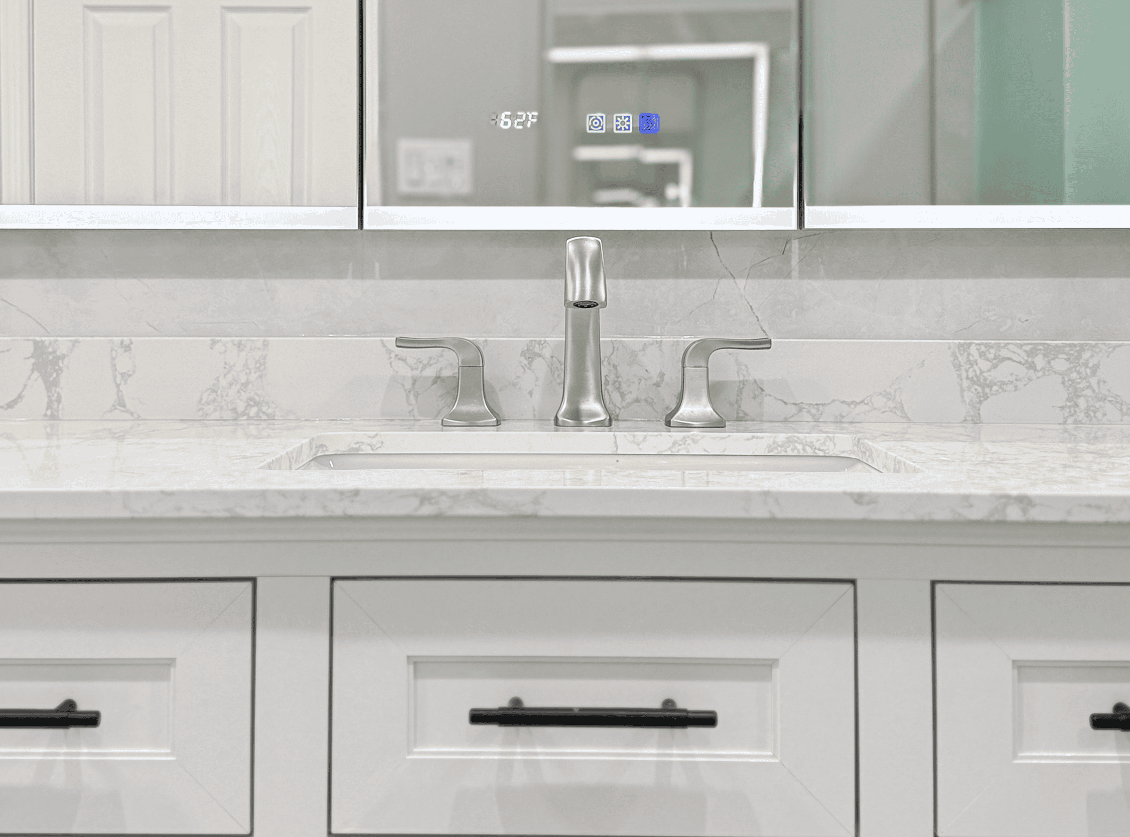 Modern kitchen sink with sleek faucet and marble countertop.