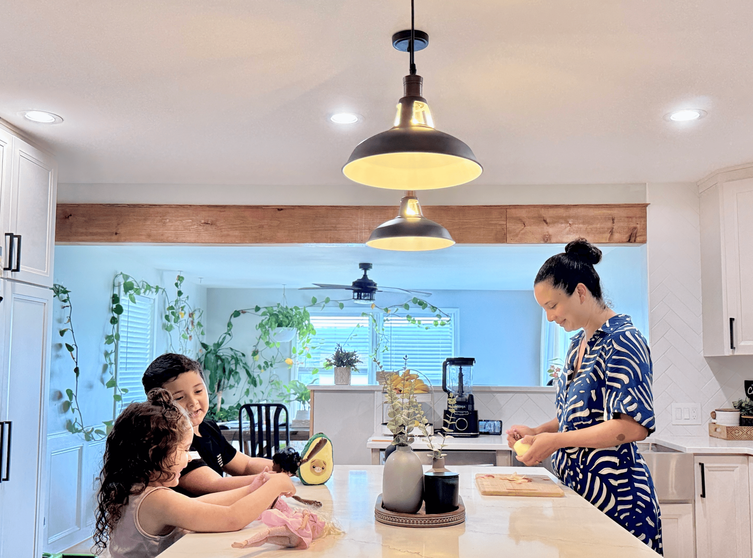 Bright, modern kitchen with family preparing food and cooking together.