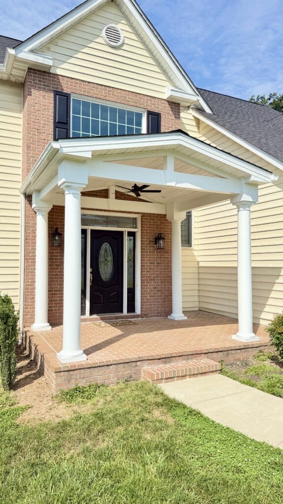 Beautiful front porch with classic columns and modern design elements. Perfect for enhancing curb ap.