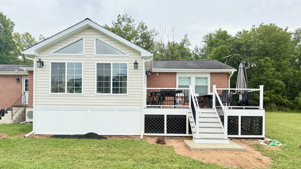 Beautiful modern home with a spacious deck and large windows, perfect for outdoor living and family.