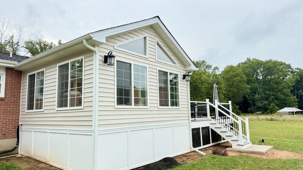 Beautiful home with fresh siding and new windows, showcasing professional exterior improvement servi.