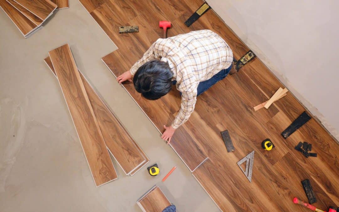 Installing new hardwood flooring in a home renovation project.